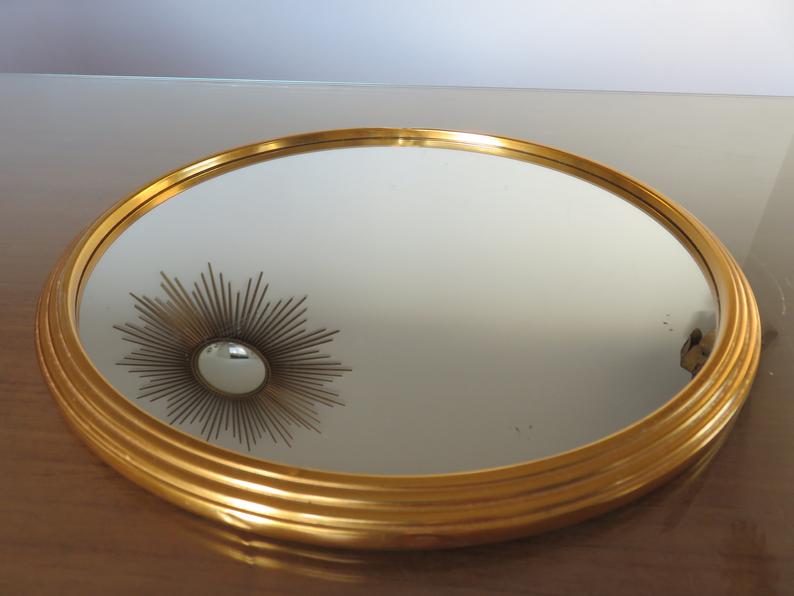 Round mirror tray in 1950s gold metal