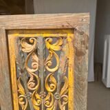 Rectangular Indonesian construction element with blue and yellow plant in carved wood