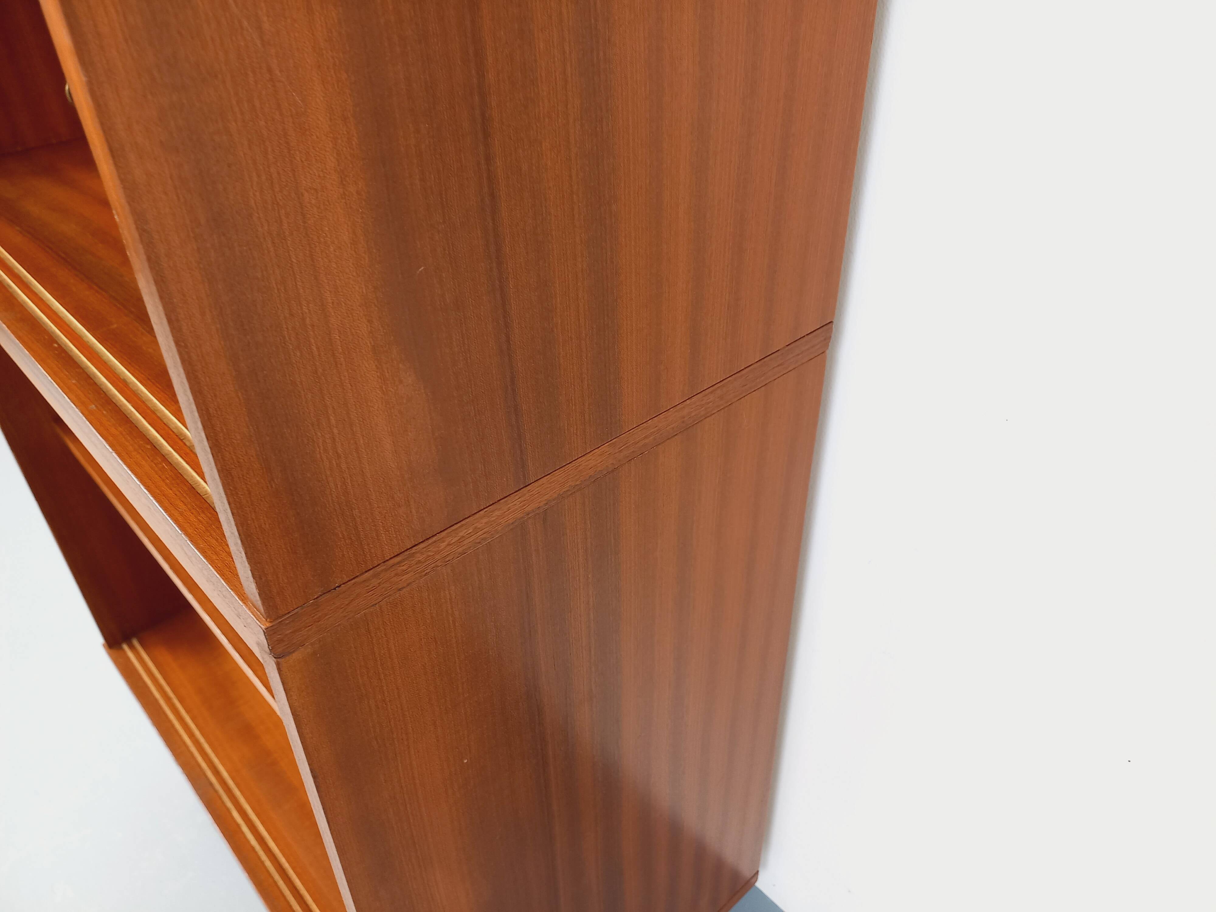 Vintage wooden bookshelf in teak style from the 1960s.