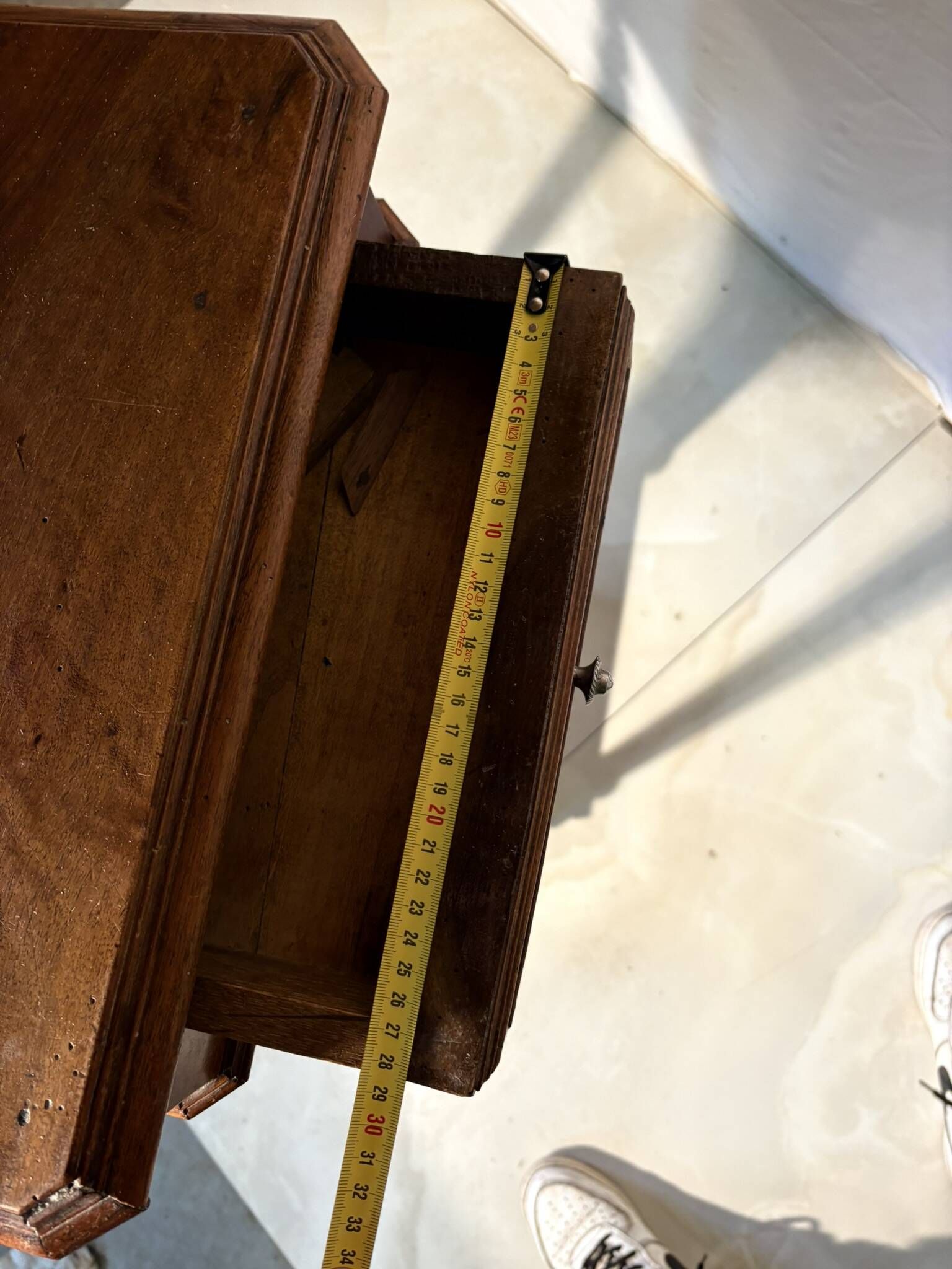 Antique wooden bedside table with turned legs.