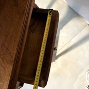 Antique wooden bedside table with turned legs.