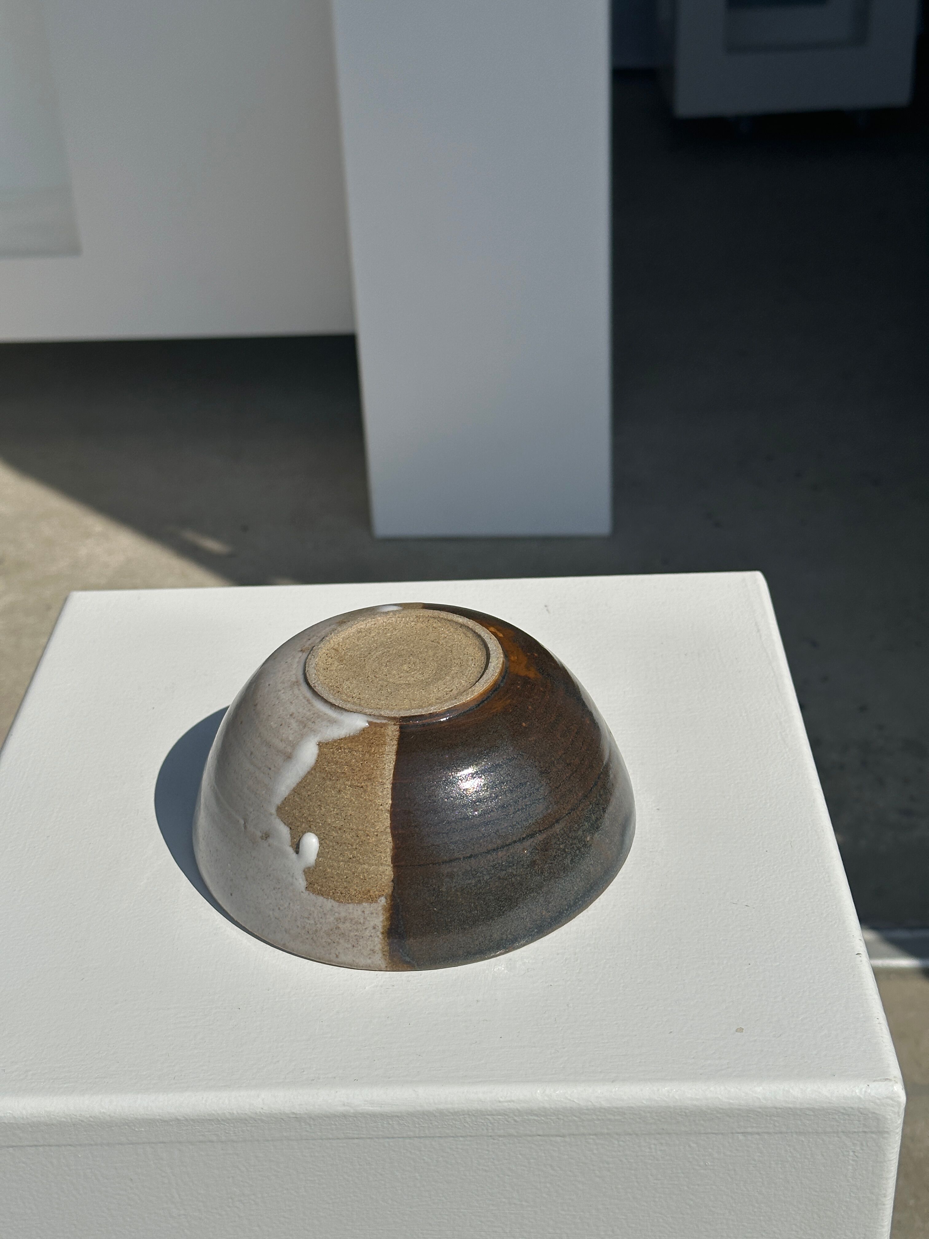 White and glossy brown two-tone ceramic bowl, matt earth