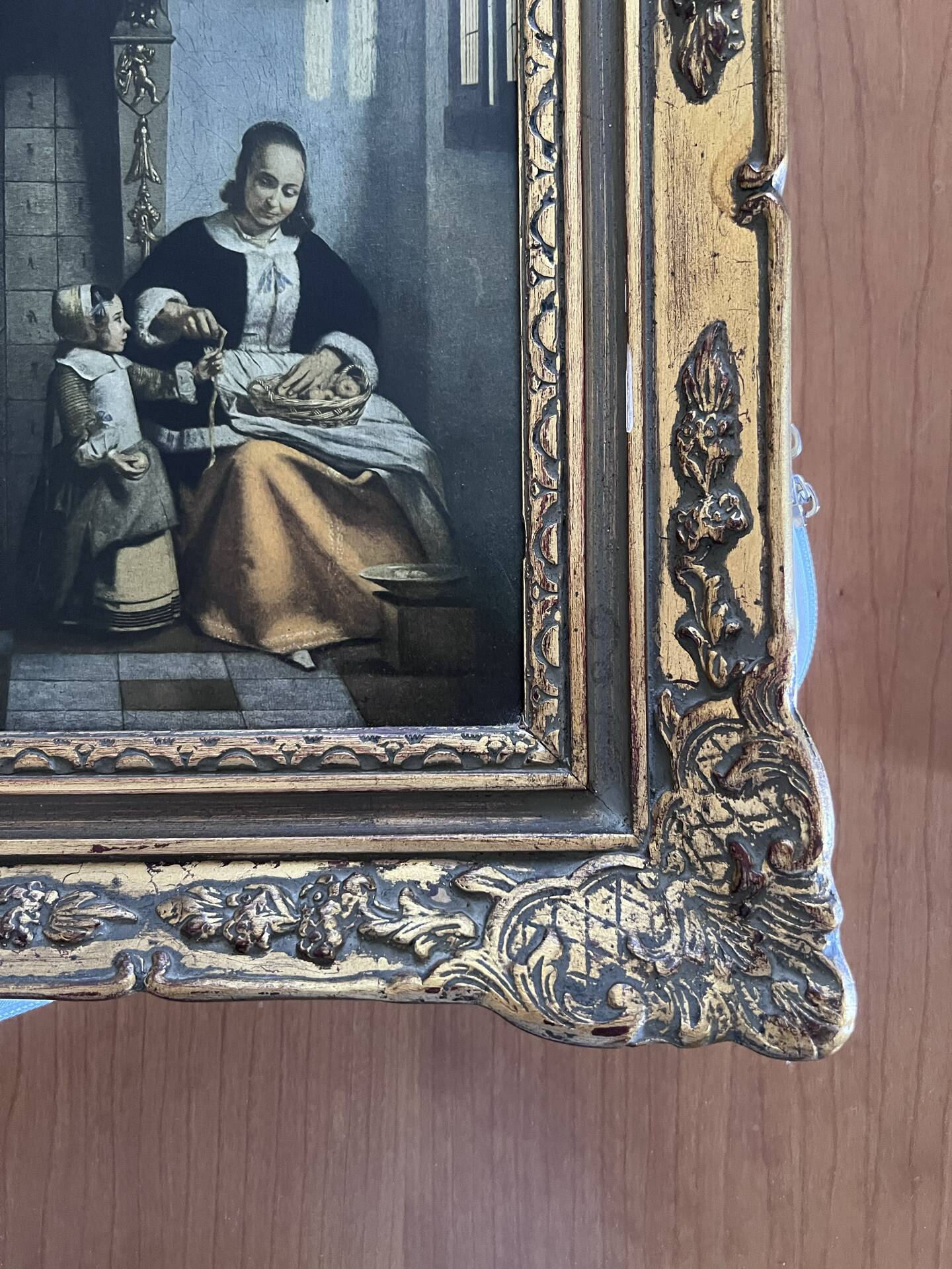 Framed reproduction painting with a golden frame.