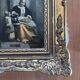 Framed reproduction painting with a golden frame.