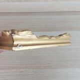 Patinated golden frame in wood and stucco