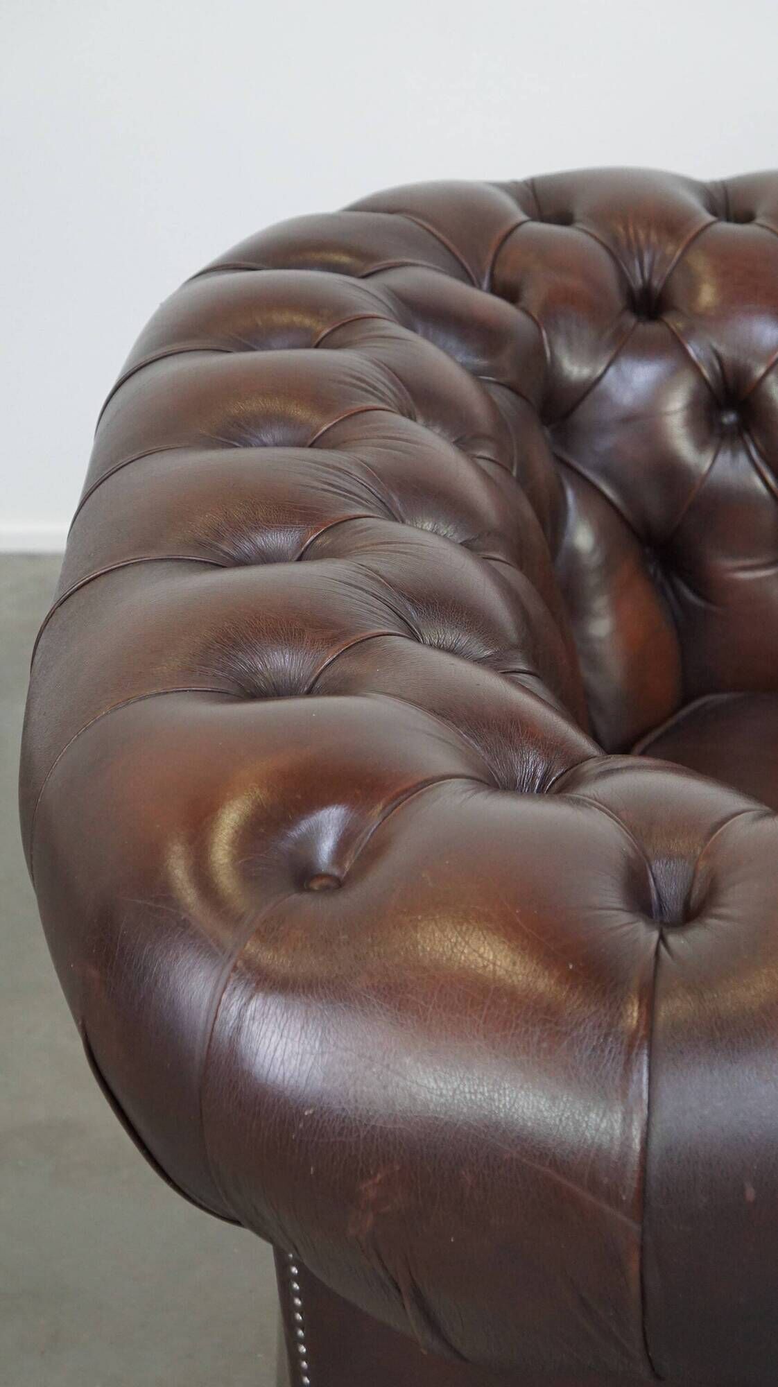 Beautiful and spacious dark brown mottled English cow leather Chesterfield armchair