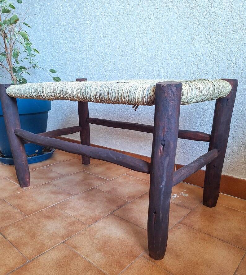 Moroccan bench in dark wood with woven palm leaf seat