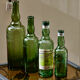 Lot de 4 bouteilles anciennes "L'Hermitage" eau d'arquebuse de Saint Genis Laval (Dept 69)