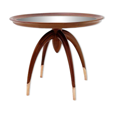 Round Art Deco side table in wood with curved legs and brass feet.