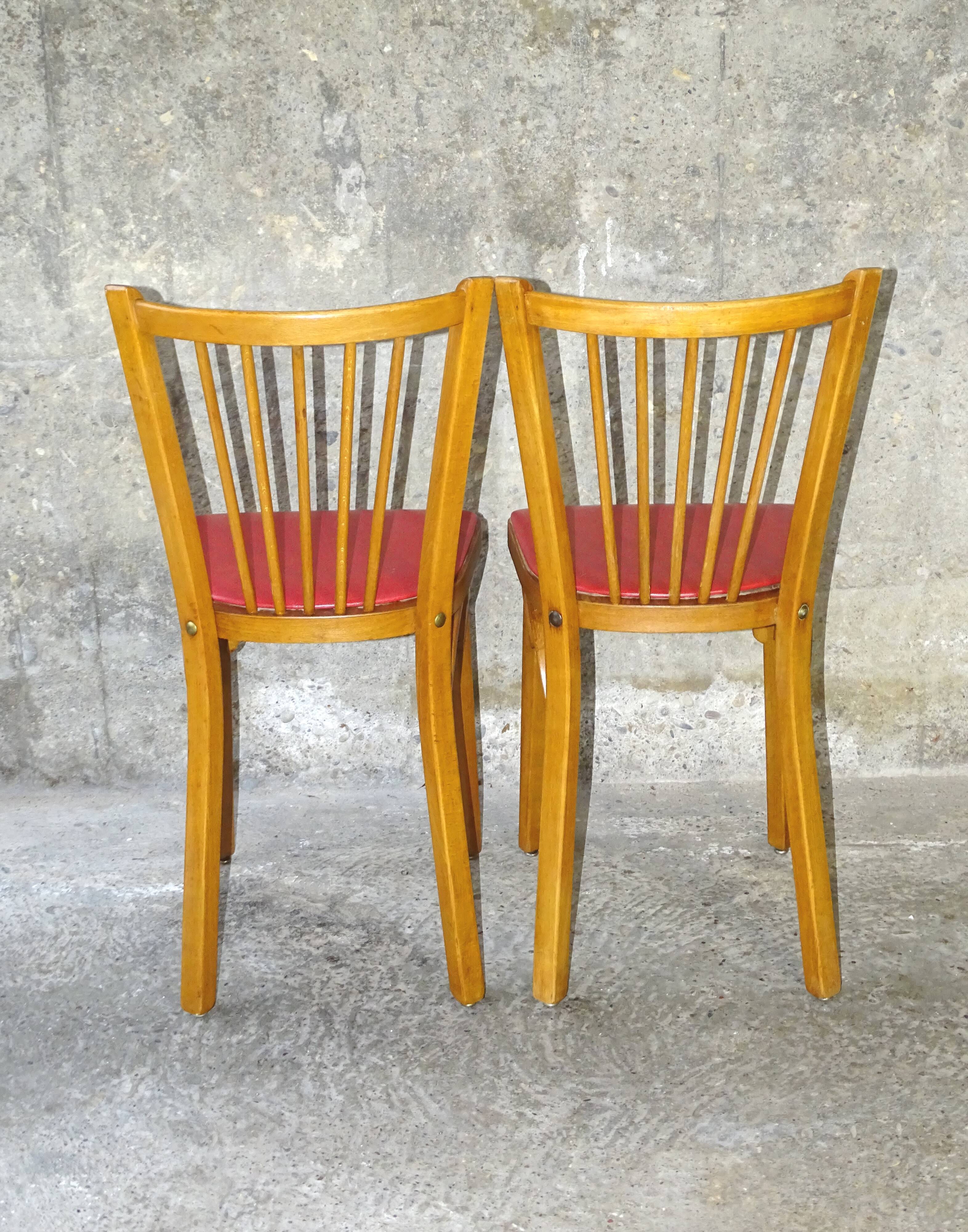 Pair of red Baumann skai chairs 1960