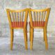 Pair of red Baumann skai chairs 1960