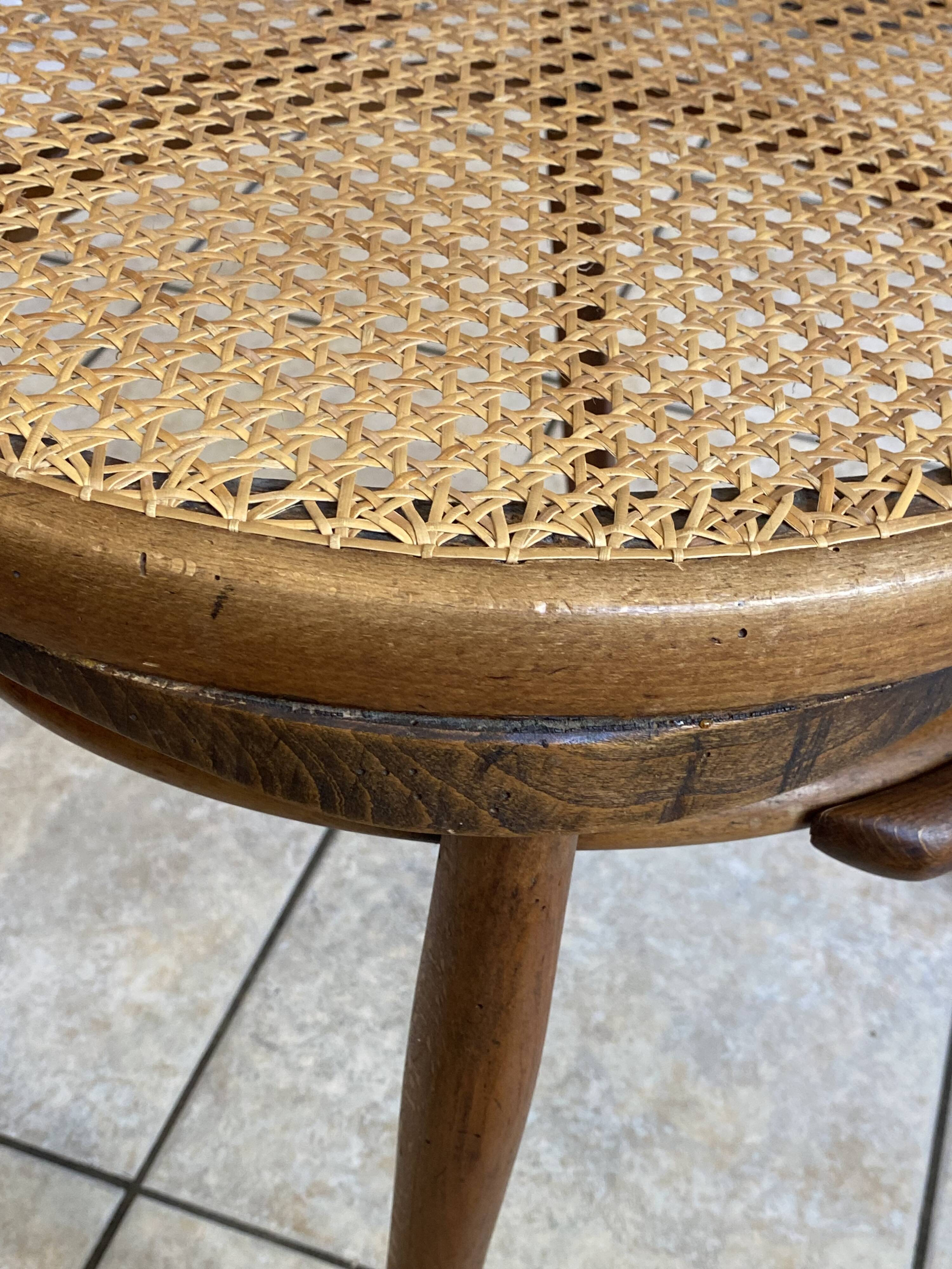 Bistro chair with a curved wooden frame and caned seat from the 1930s.