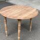 Renovated 18th century solid wood extendable round dining table with shutters
