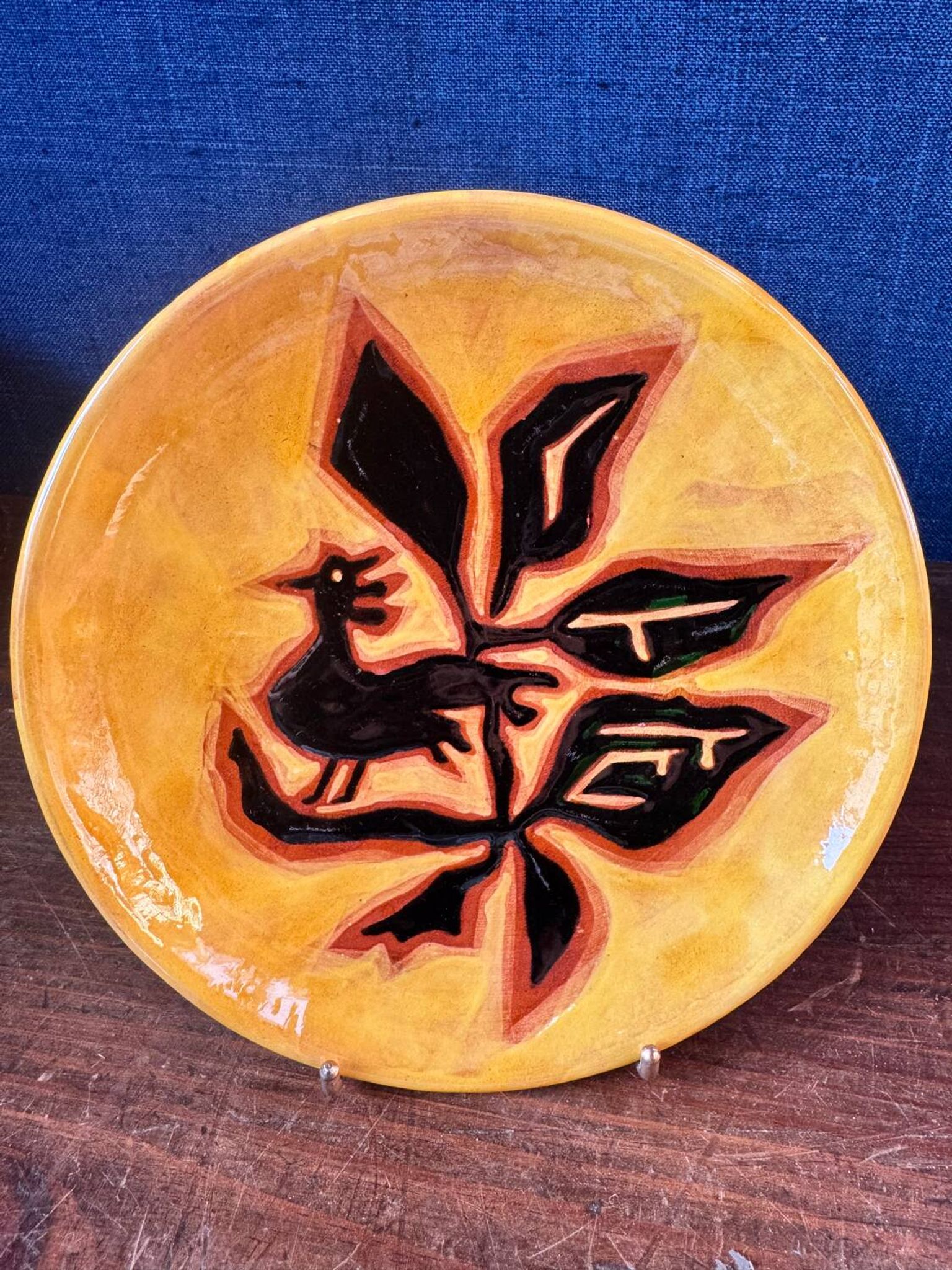 Terracotta plate, Jean Lurçat decorated with a rooster and foliage.