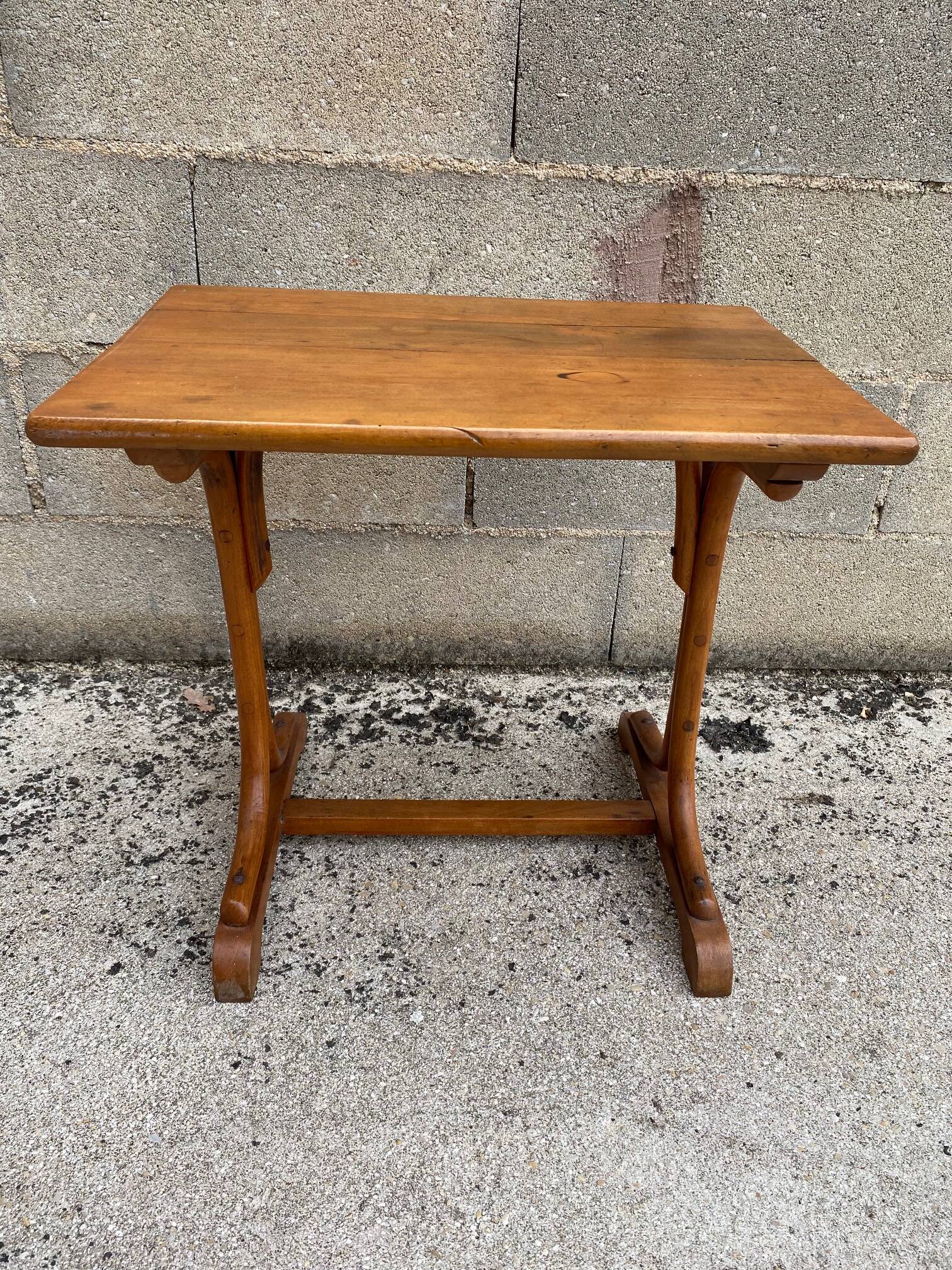 Small side table or bistro serving table with curved wood.