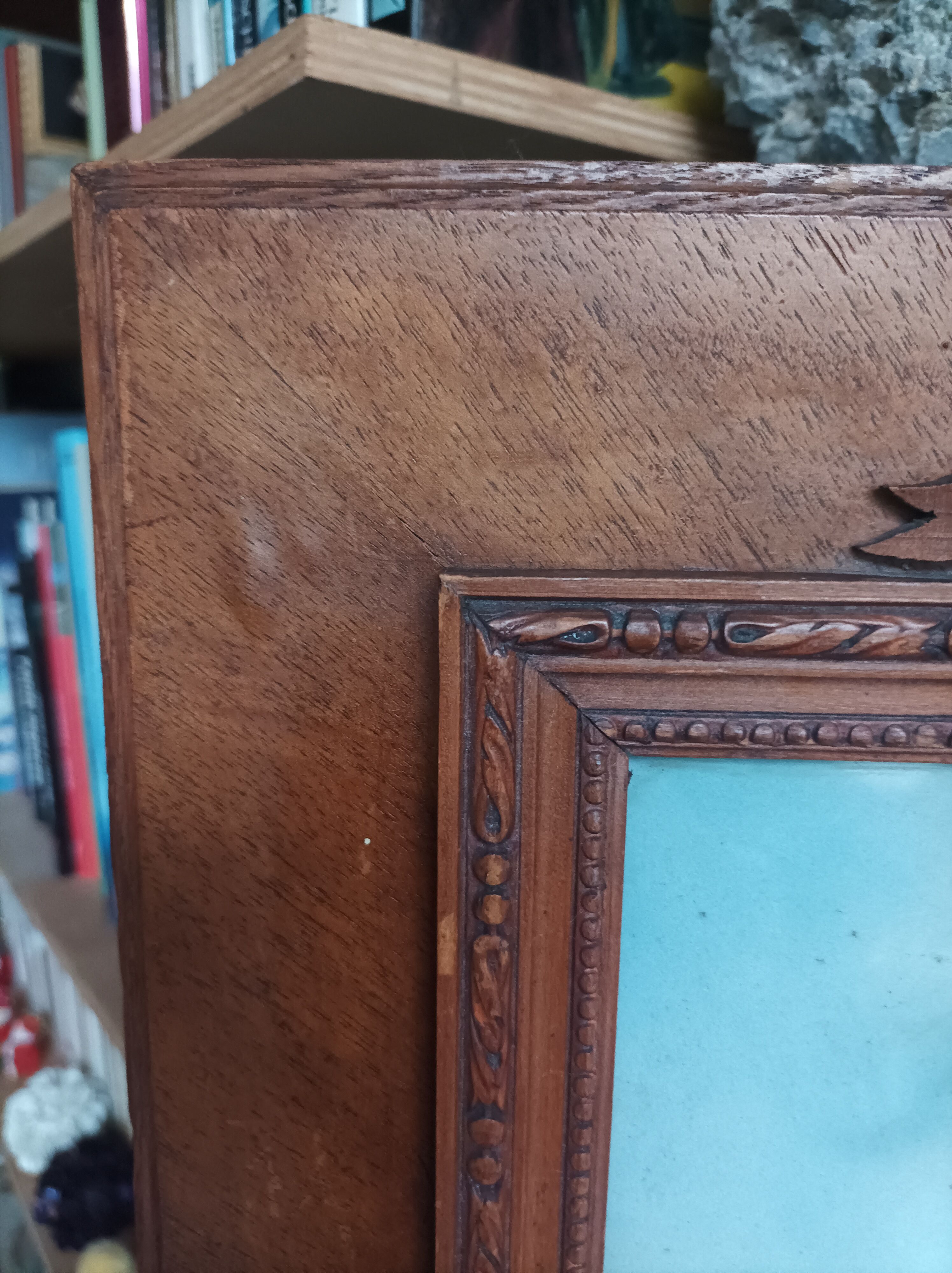 Antique wooden frame with carved portrait knot