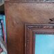 Antique wooden frame with carved portrait knot