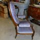 Relaxed Voltaire armchair with walnut racks