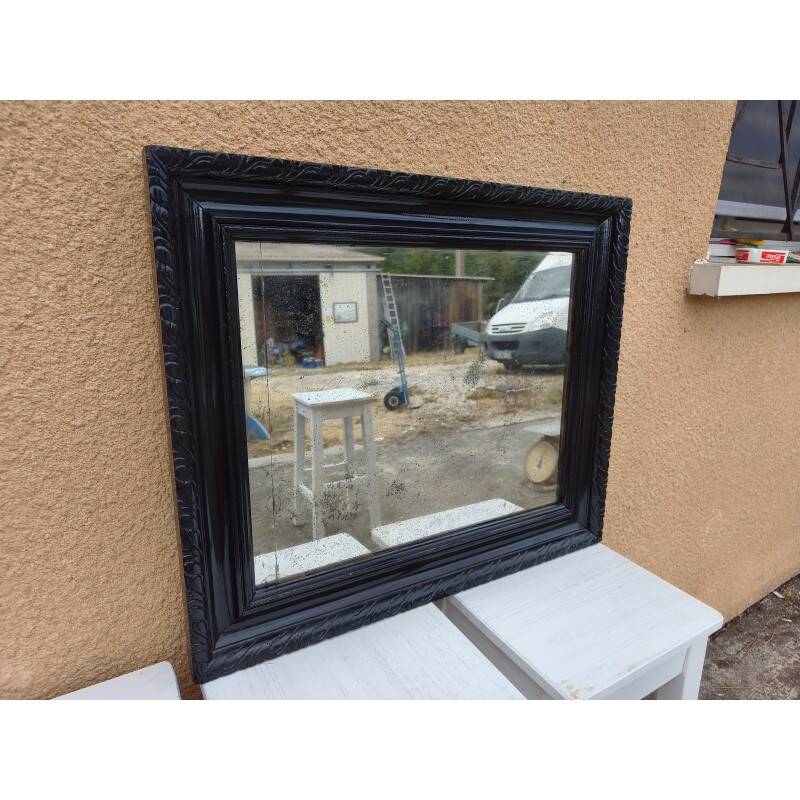 Black lacquered wood mirror "originally punctured"