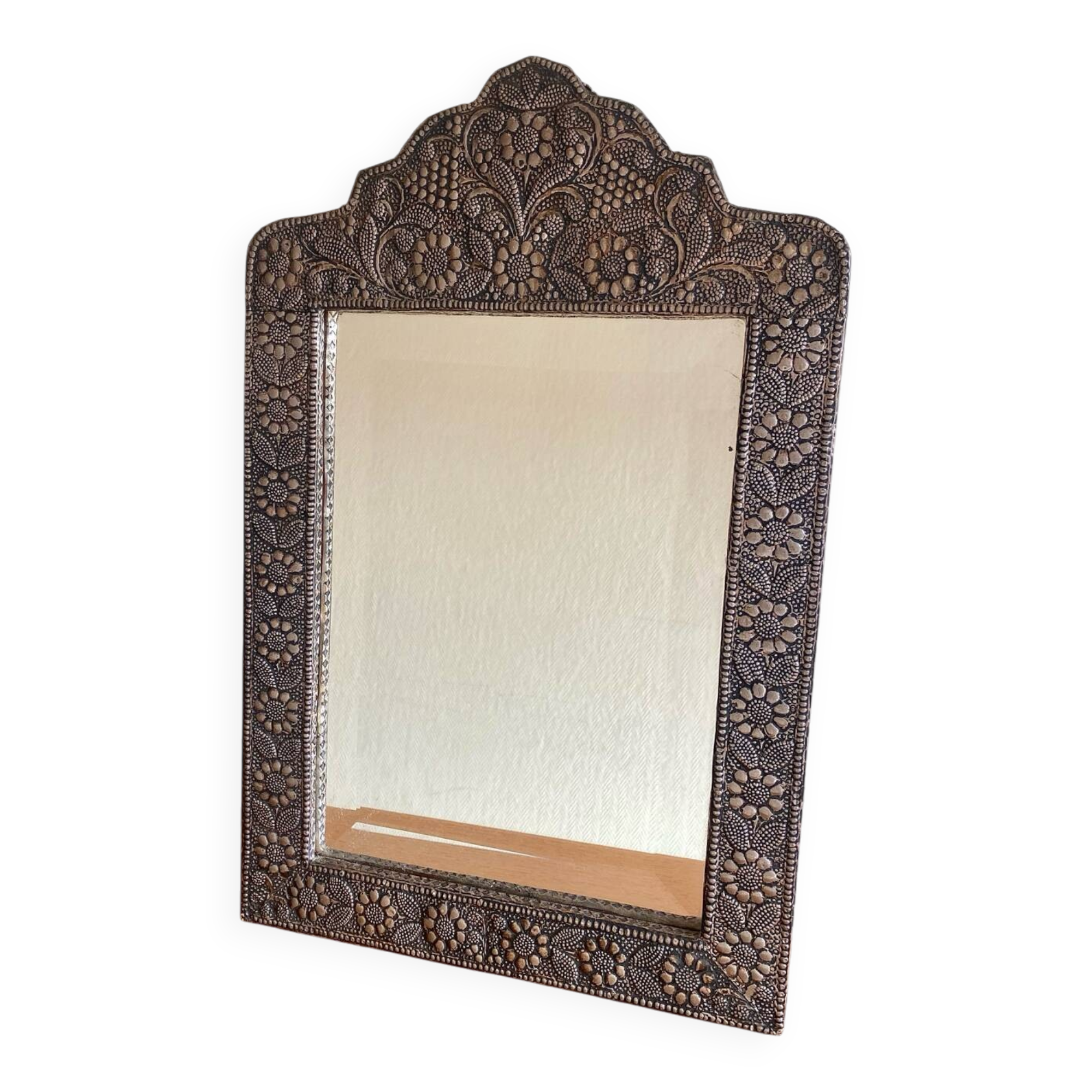 Ancient oriental mirror in embossed copper