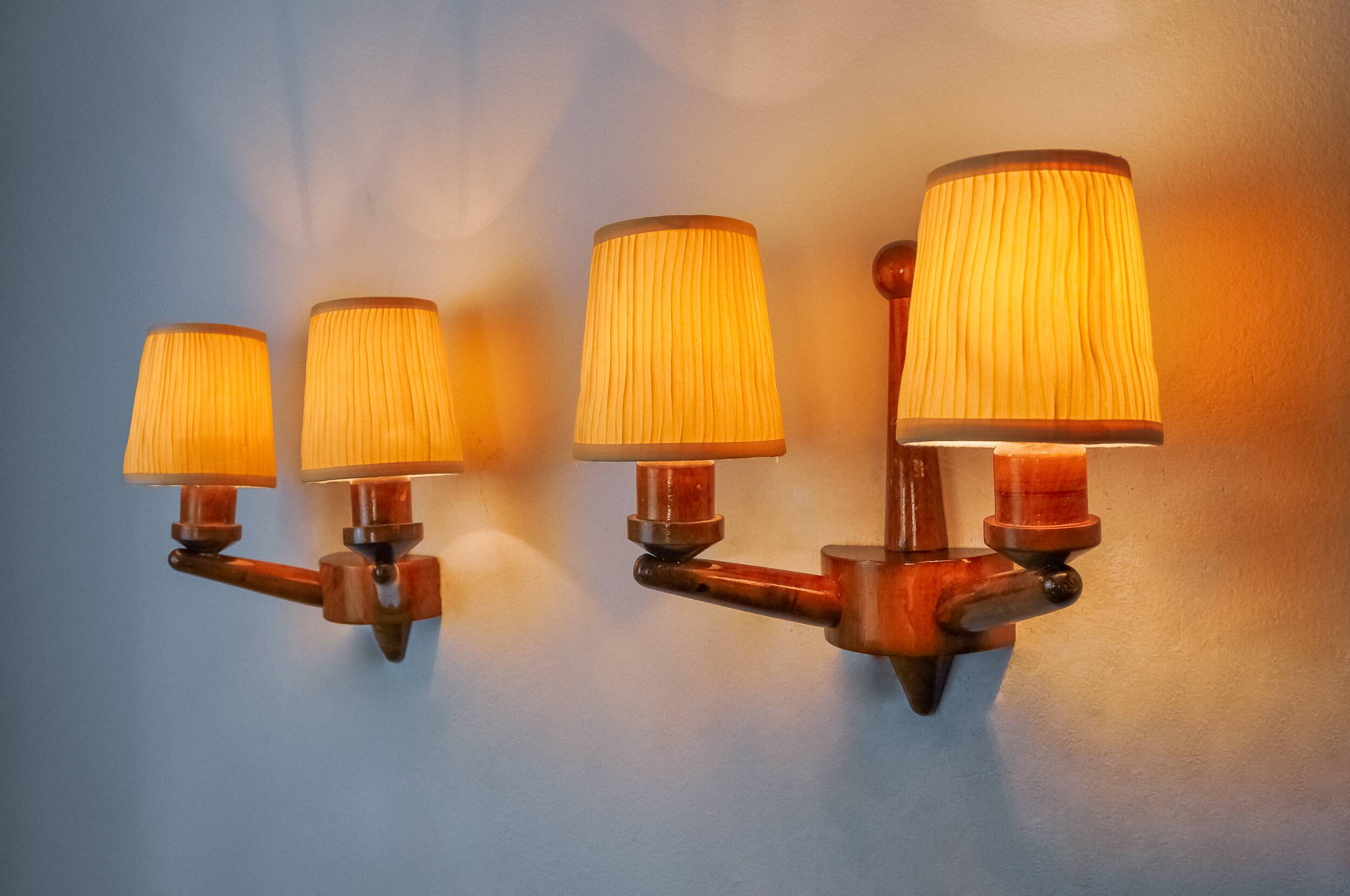 Pair of two-armed art deco "ball" wall lights, carved wood, France, 1960