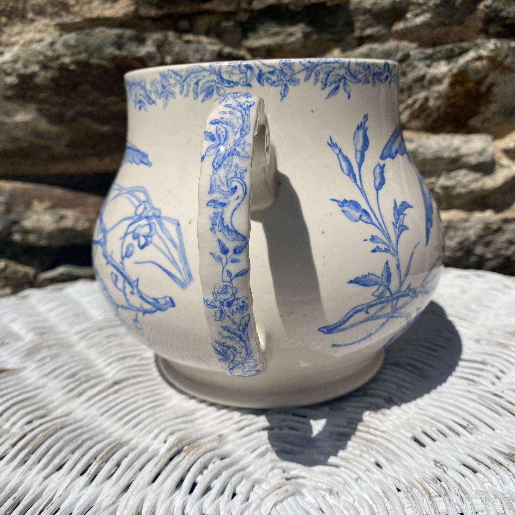Earthenware pitcher decorated with birds.