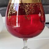 Vase in the shape of a footed cup, in bohemian crystal. ruby color. scroll & floral design with 24 c gold highlights