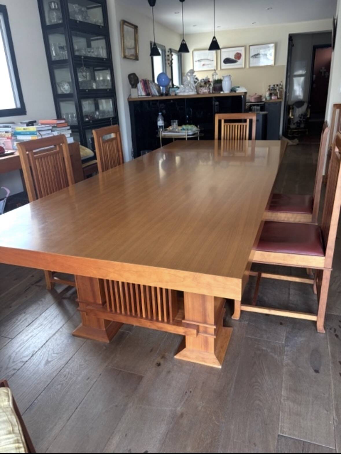 "Frank Lloyd Wright set with a table and its eight chairs."
