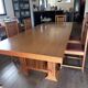 "Frank Lloyd Wright set with a table and its eight chairs."