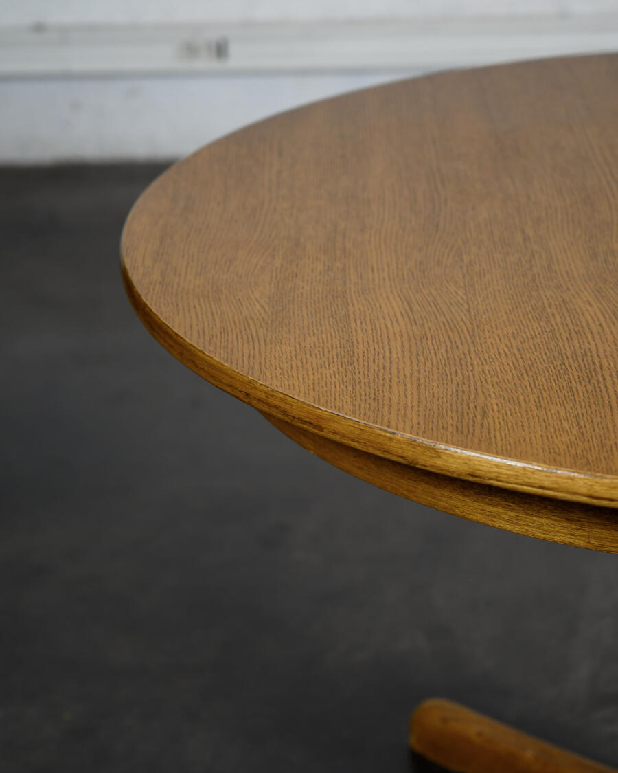 Round teak table with an extension.