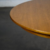 Round teak table with an extension.