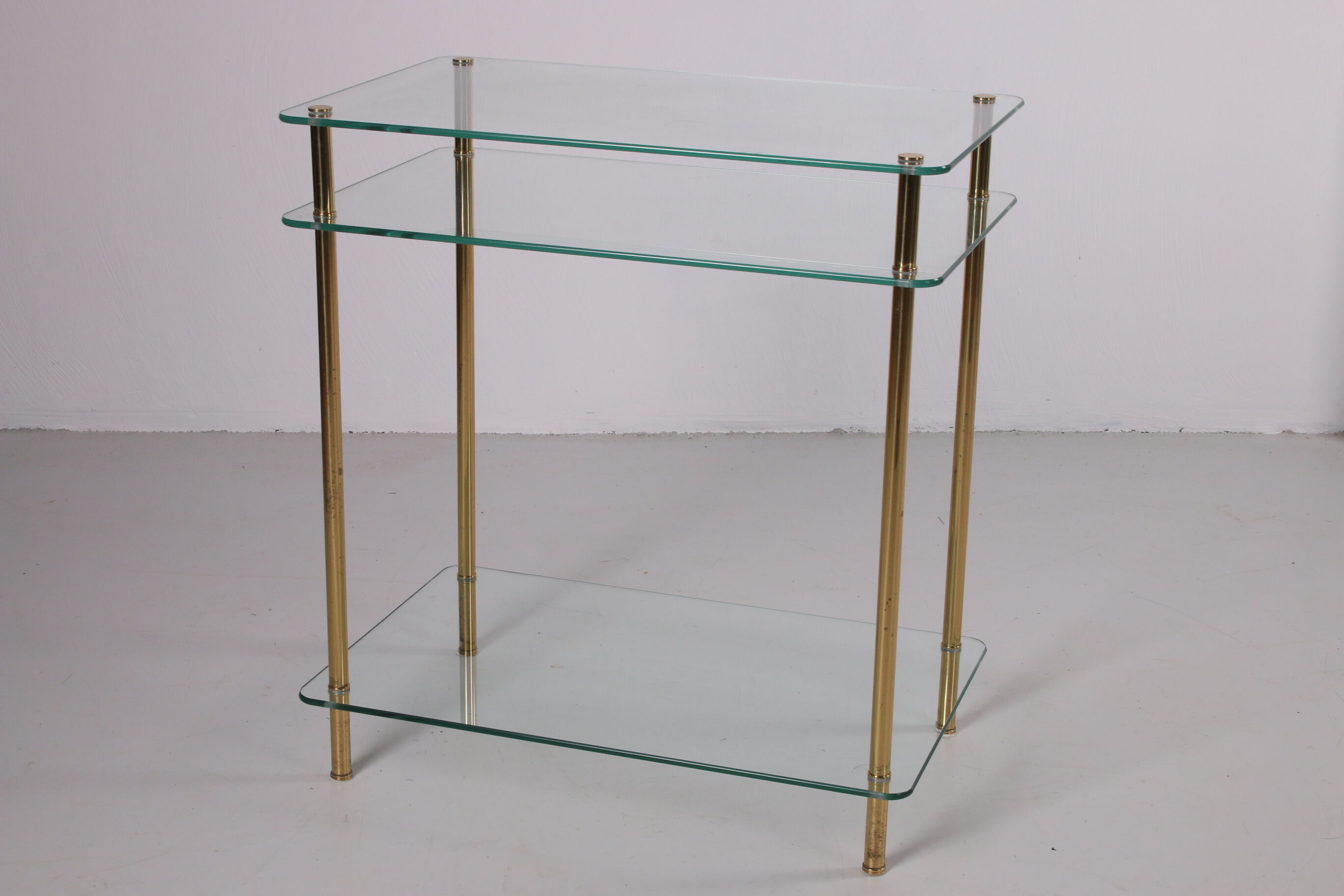 Hollywood Regency side table with gold-colored legs
