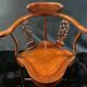 Corner armchair in solid wood with carved floral decoration featuring a bird.