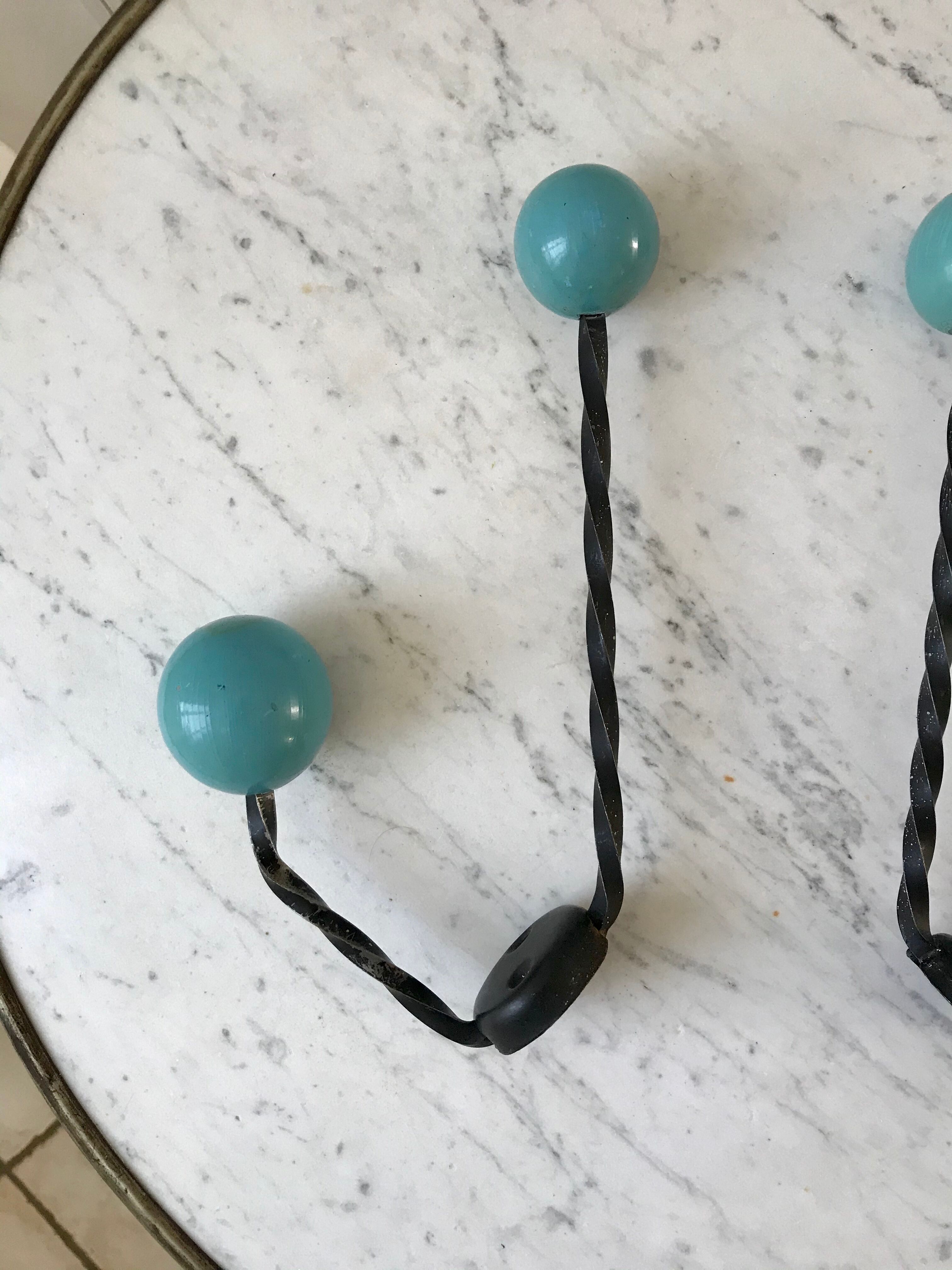 Duo of hooks balls in blue wood and black iron 60s