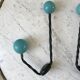 Duo of hooks balls in blue wood and black iron 60s