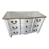 Patinated crossbow chest of drawers.