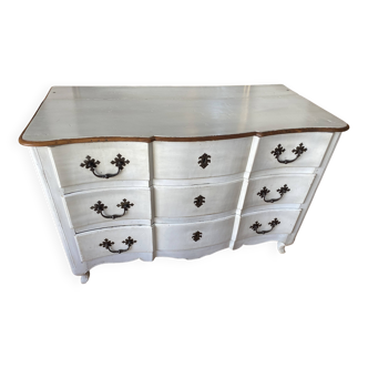 Patinated crossbow chest of drawers.