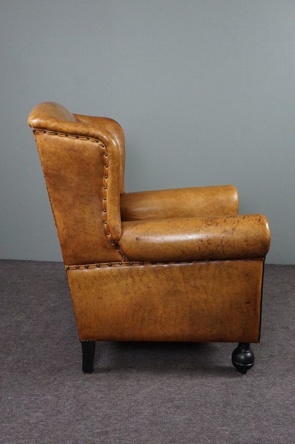 Antique armchair in patinated sheepskin