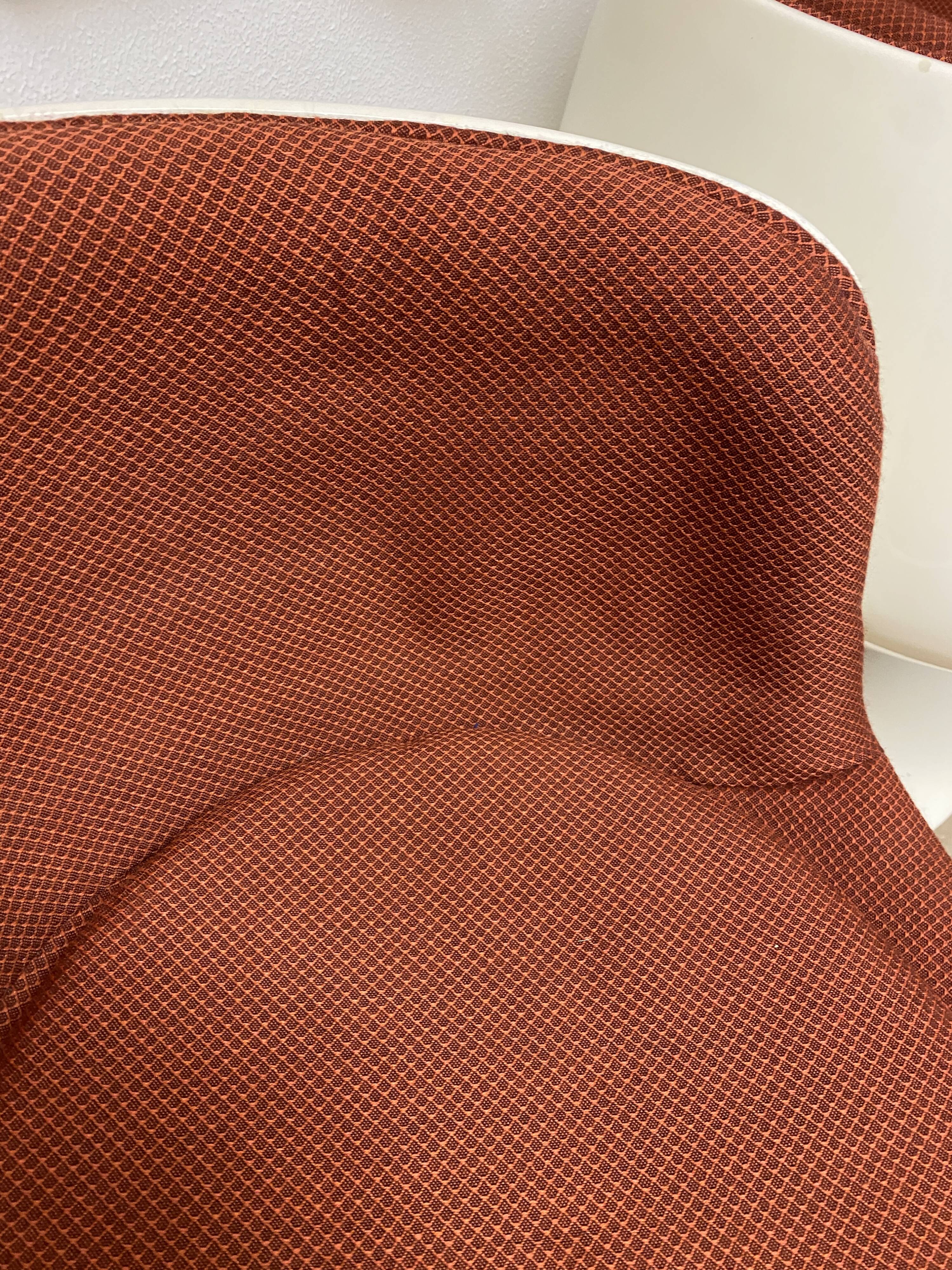 Two cognac-colored swivel chairs made of fiberglass from the 1970s