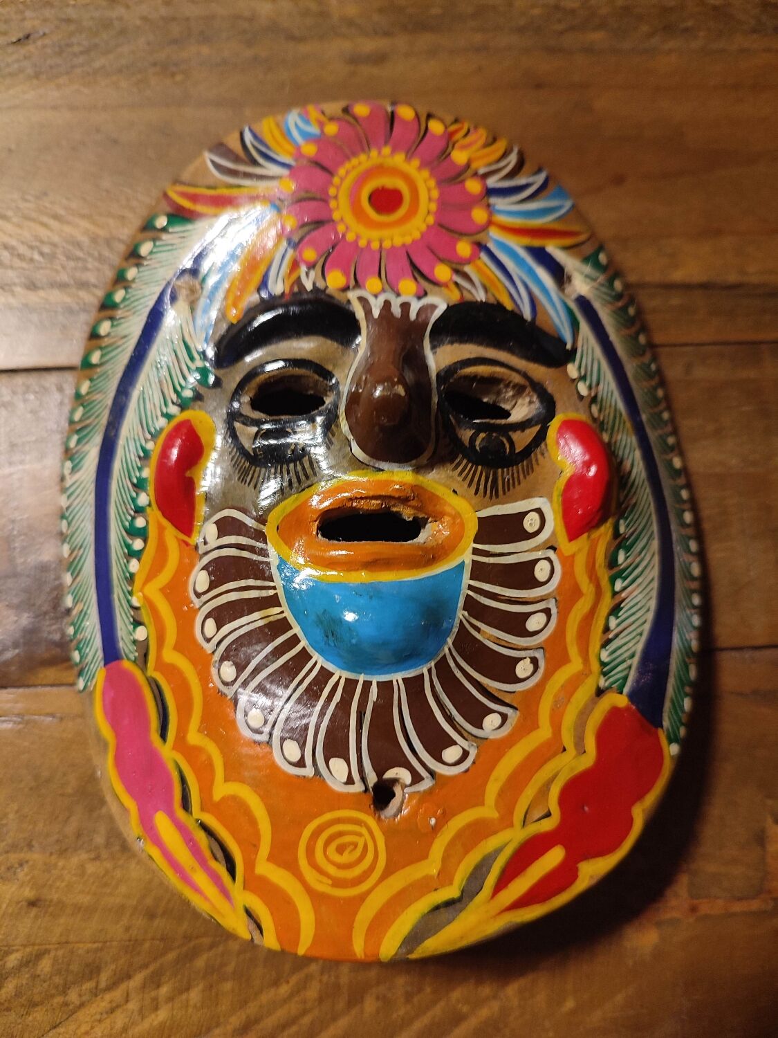 Mexican mask from the 1970s, hand-painted on terracotta.