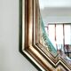 Vintage octagonal mirror, molar glass, patinated green silvering, floral decoration.
