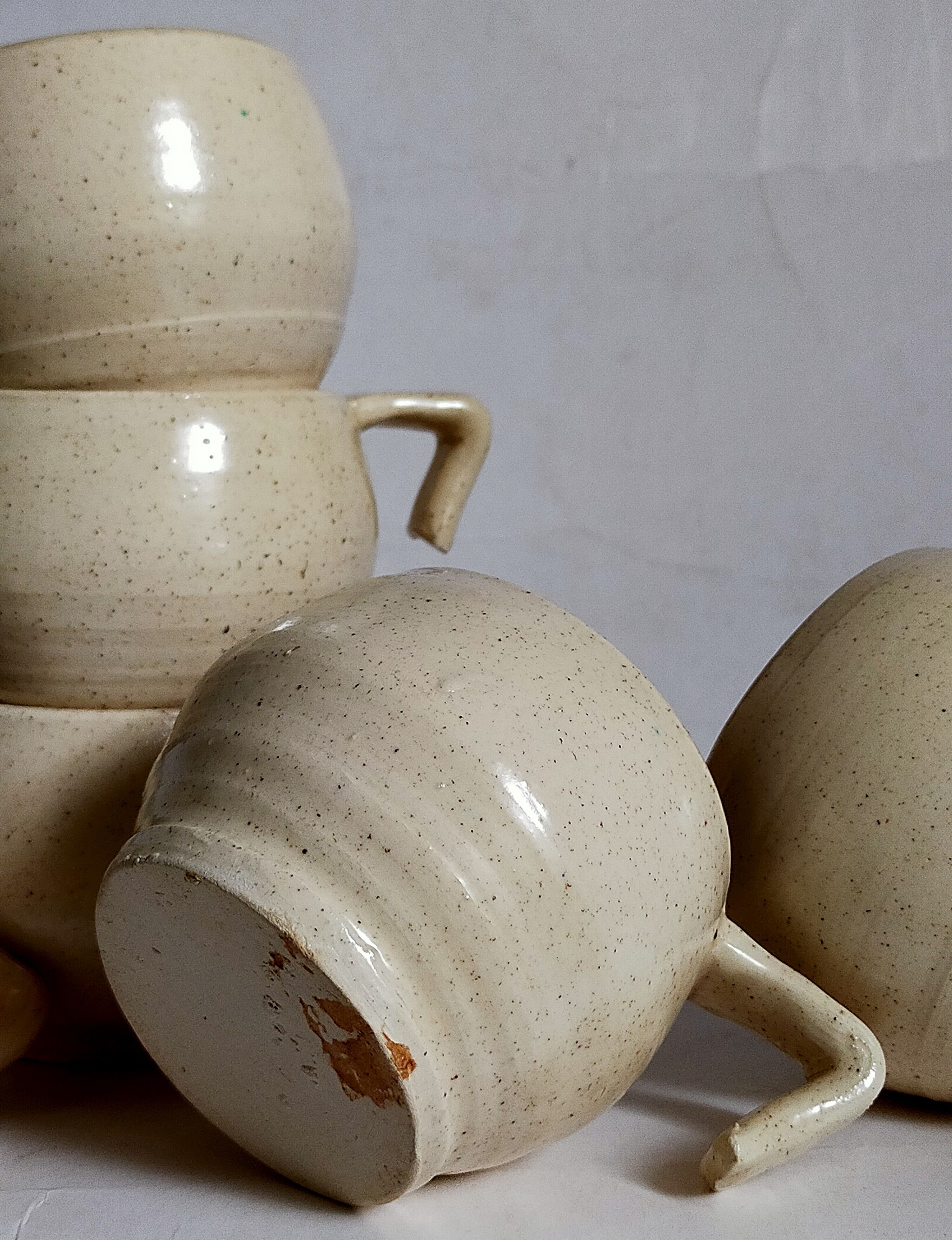 Six vintage potter's ceramic cups with vanilla enamel