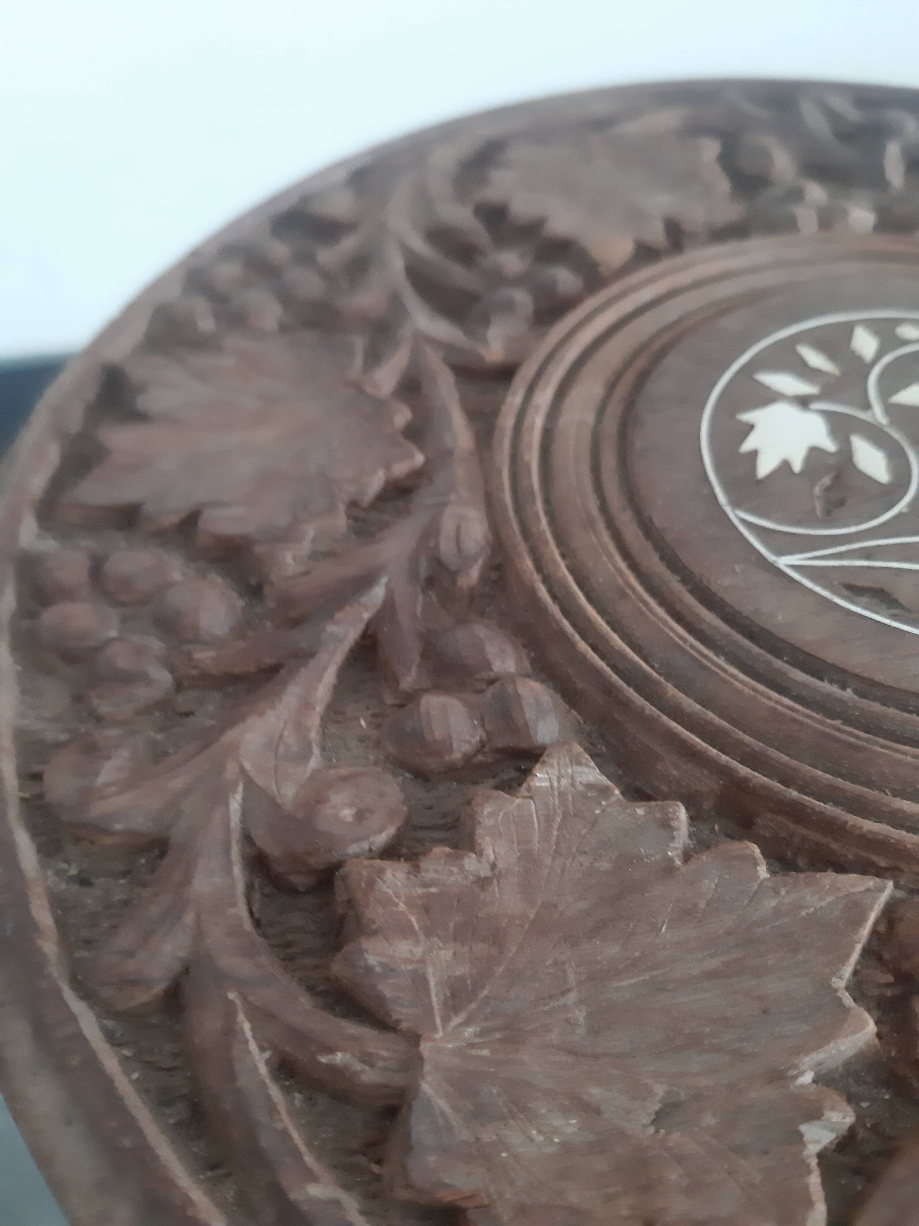 Carved wooden hunting stool decorated with vines