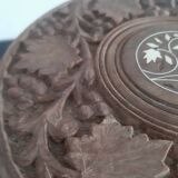 Carved wooden hunting stool decorated with vines