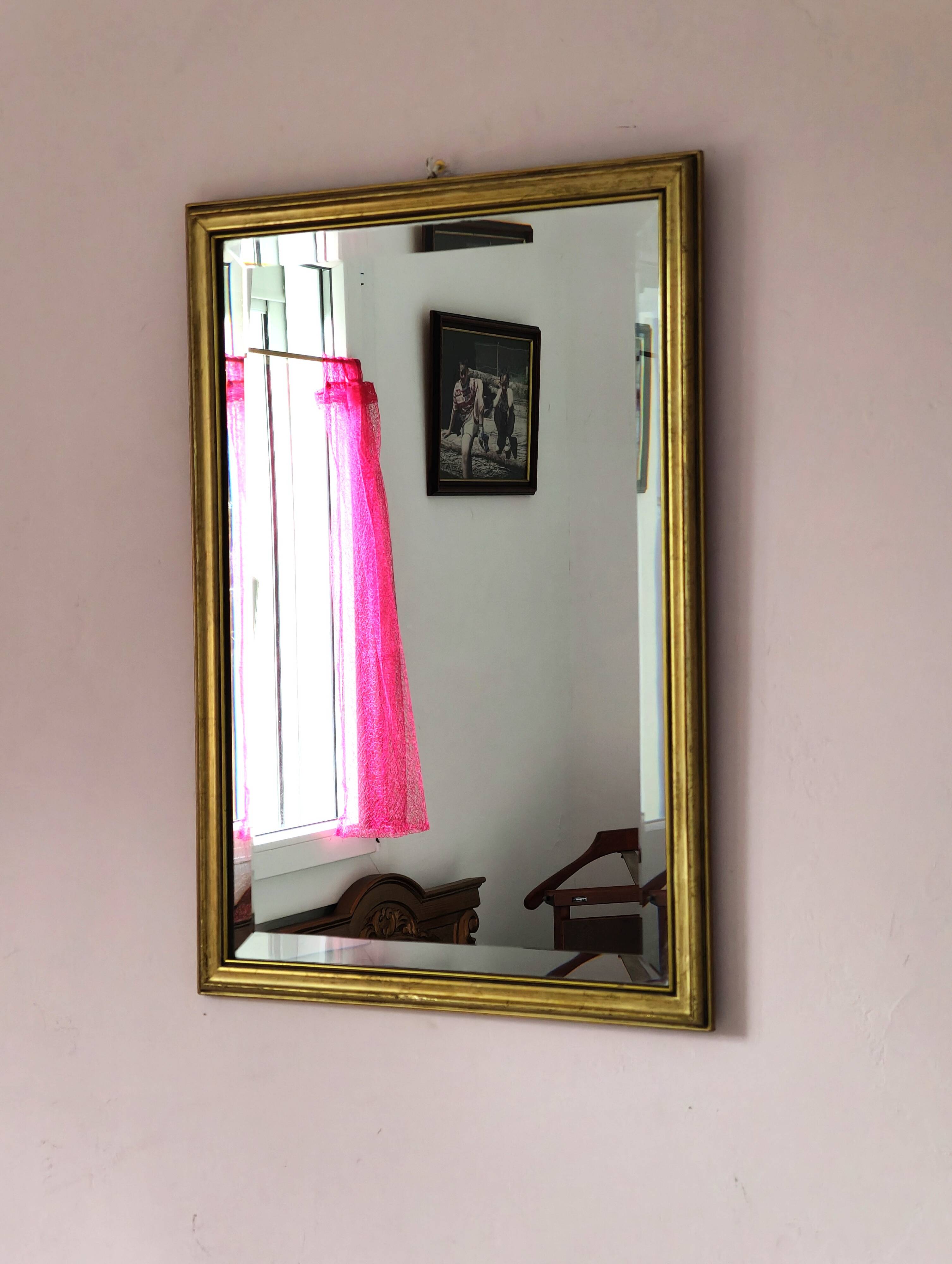 Rectangular gold mirror with bevelled glass.