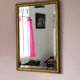 Rectangular gold mirror with bevelled glass.