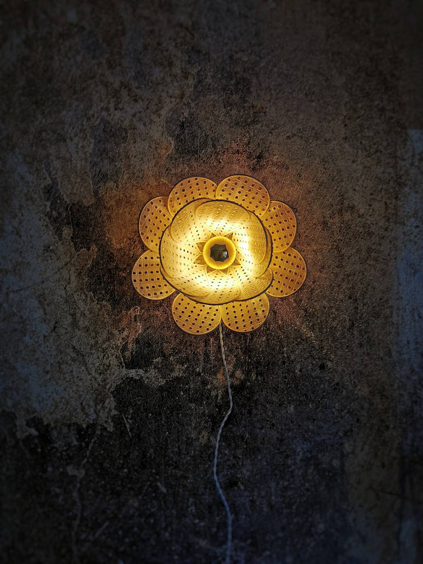 Flower wall light made of rattan petals and nude embroidery