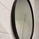 Round mirror 75cm in diameter with a black frame.