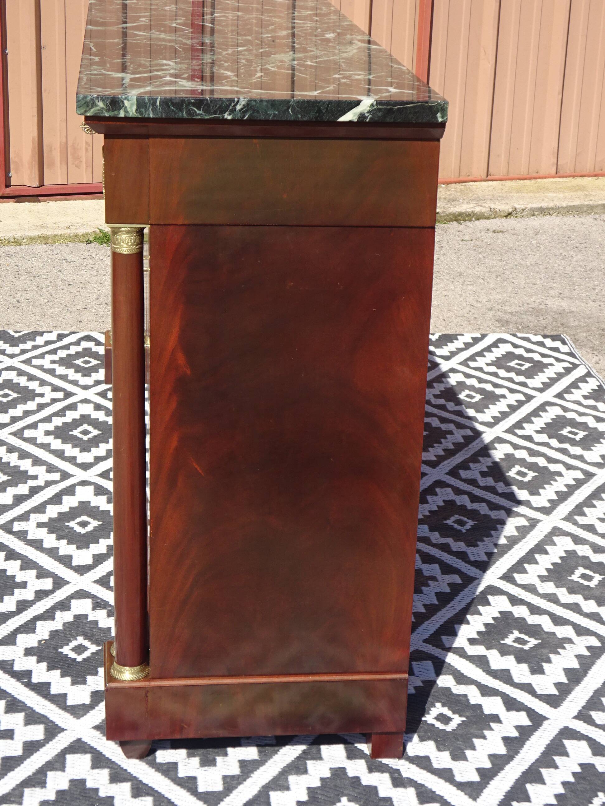 Flamed mahogany enfilade with sea green marble in Empire style.