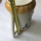 Antique barbotine pitcher with floral decoration numbered 548